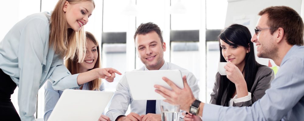 Group of business people working with digital tablet in office